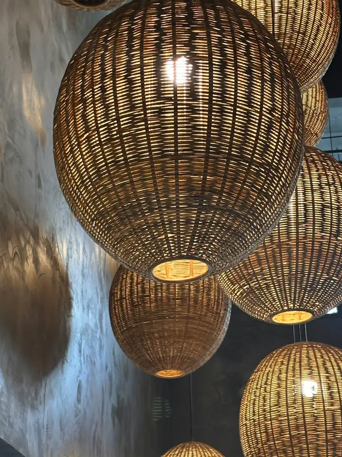 Woven spherical rattan pendant lamps glowing