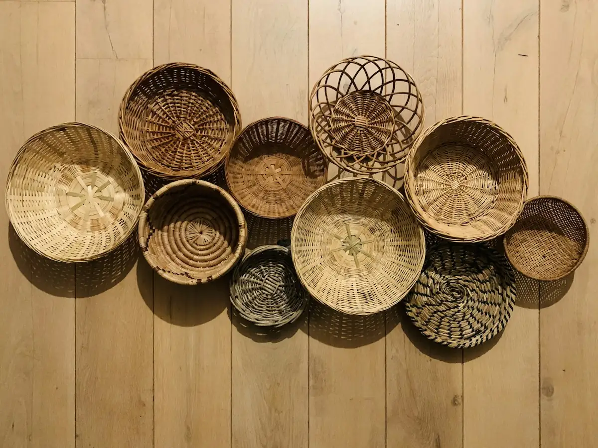 Round woven baskets arranged on a wooden wall