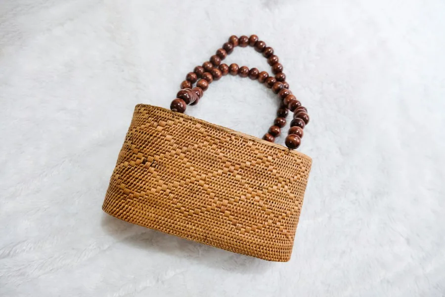 Rattan clutch with wooden bead handles on a white rug
