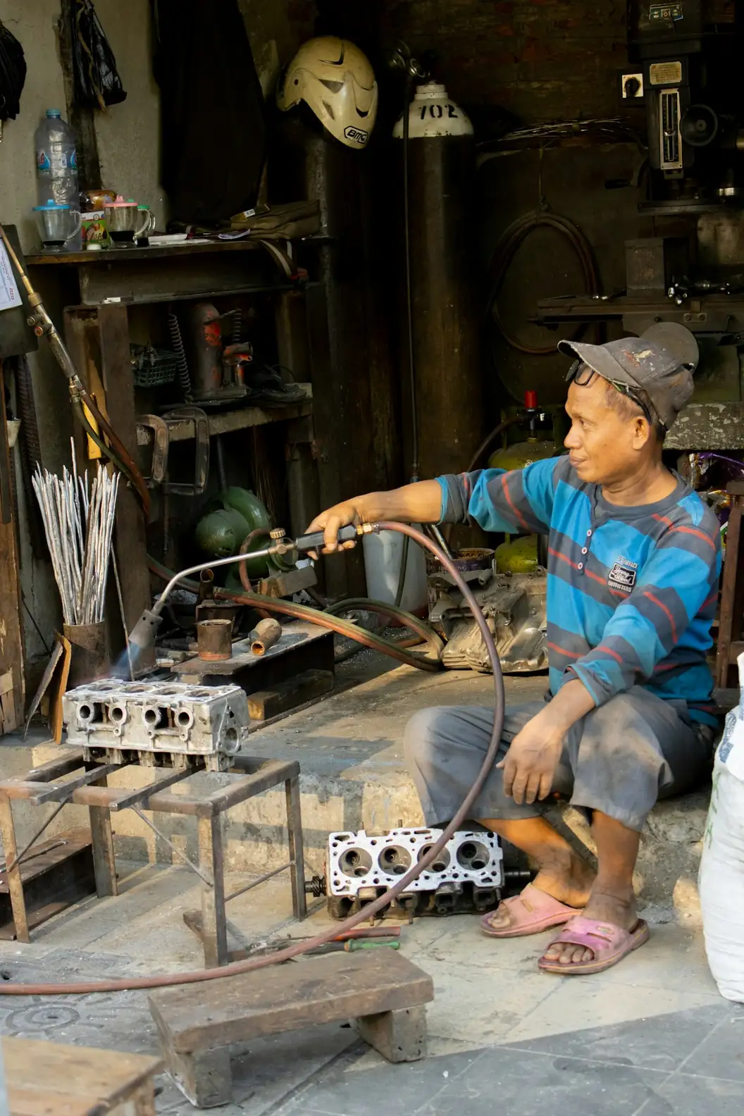 Indonesian craftsman working in a busy workshop