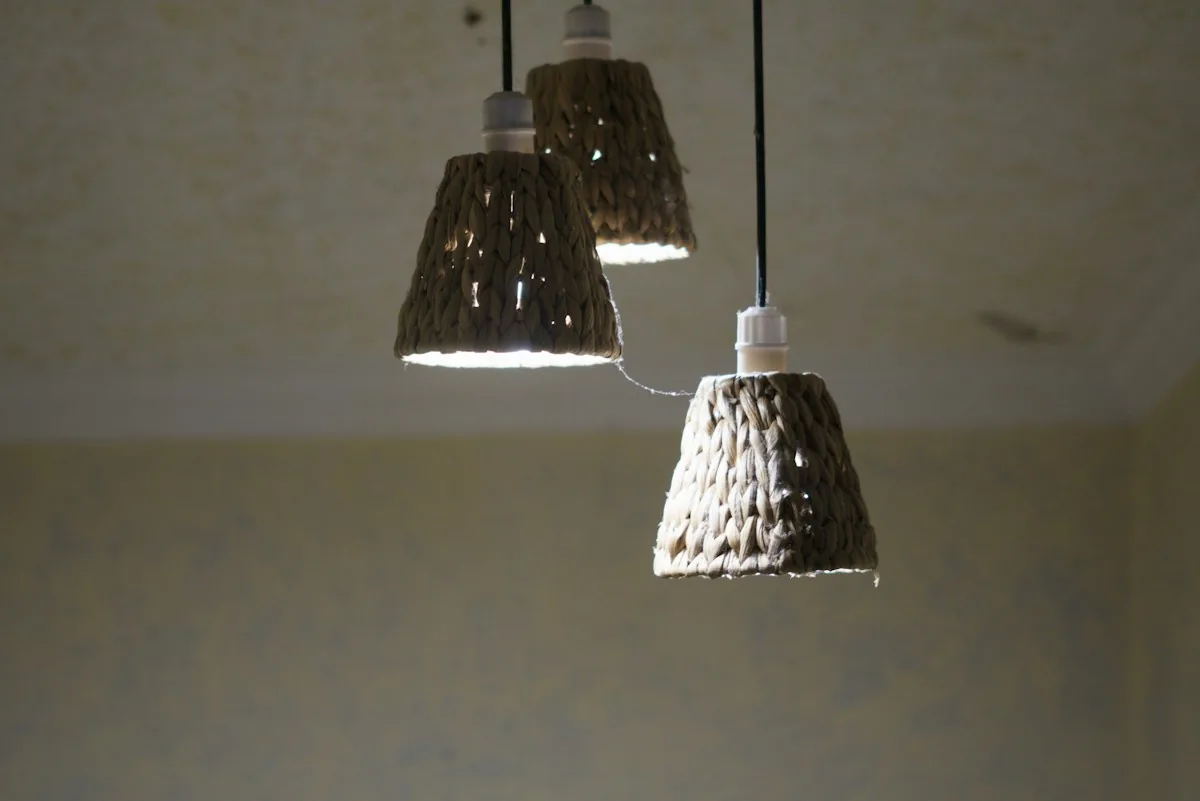Three woven rattan pendant lamps hanging in a room