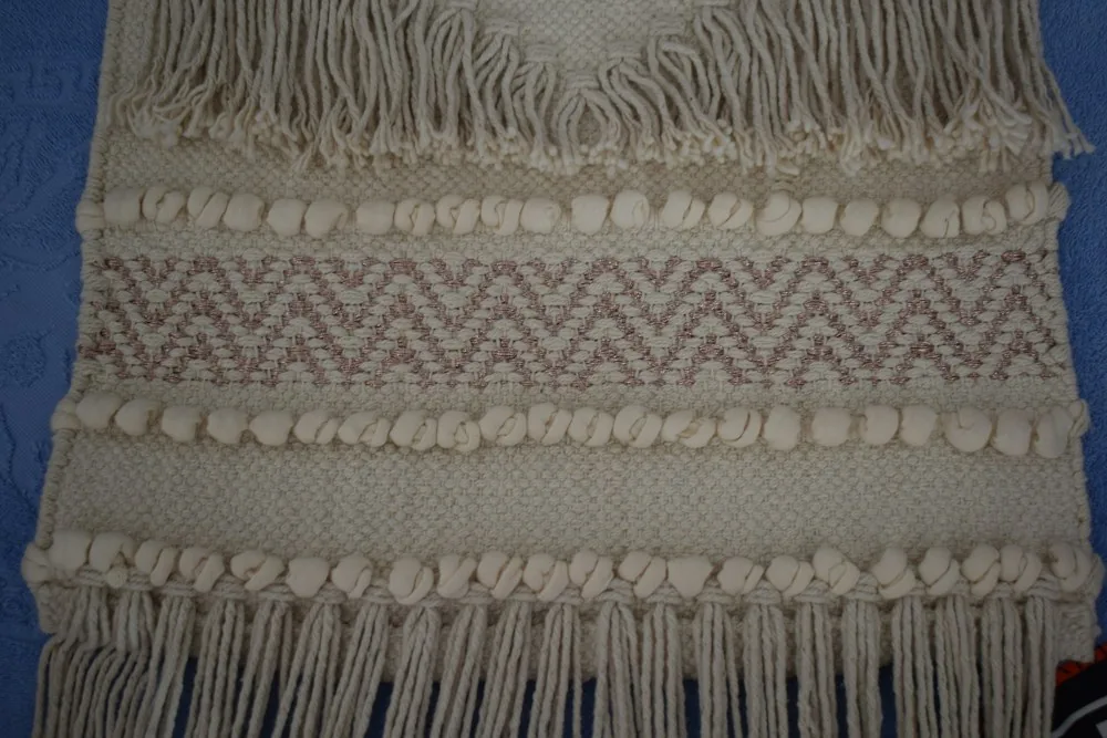 Cream woven wall hanging with knotted texture