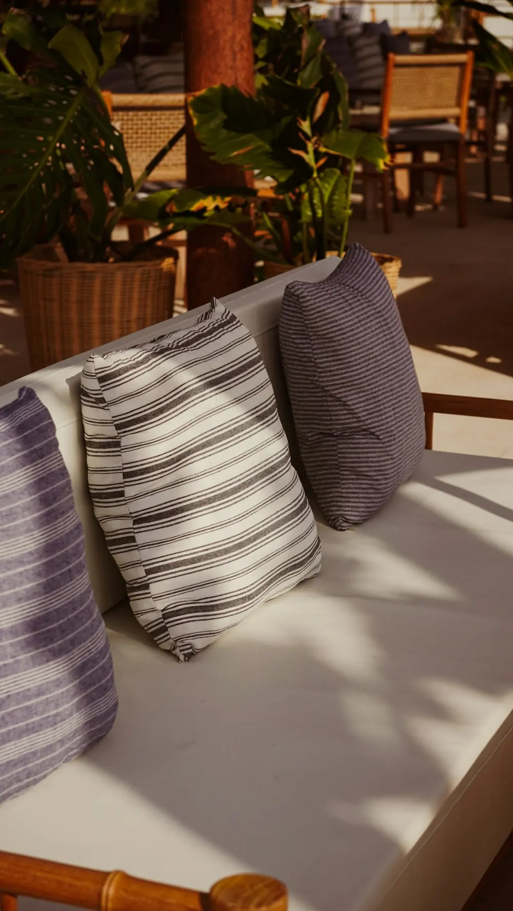 Outdoor lounge daybed seating with striped pillows